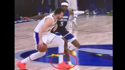 Luka Doncic tripping over an opponent's foot