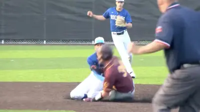 A high school player slides into second base