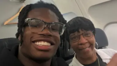 Travis Hunter takes a photo with a fan on a flight