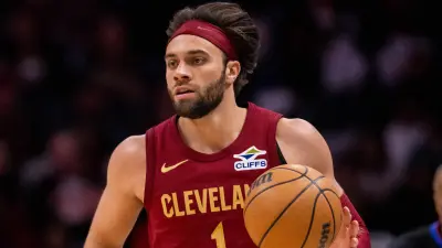 Cavaliers wing Max Strus dribbles a ball