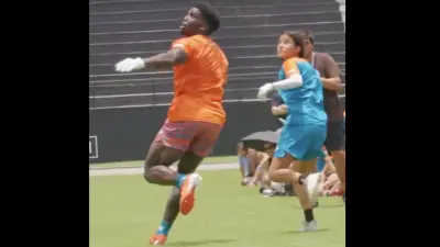 Tyreek Hill defends a young girl during one of his camps