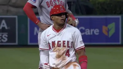 Angels player Christian Moore kneeling on third base