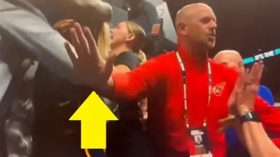 A security guard with his hands out