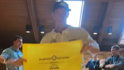Ted Scott holds up a sign