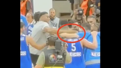 Giannis Antetokounmpo slapping his Greek teammate in the back of the head