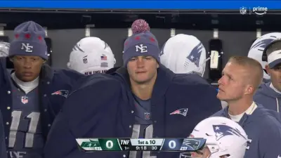 Drake Maye wearing a coat