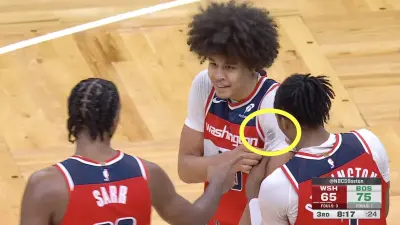 Kyshawn George and his Wizards teammates react after Jaylen Brown's fake hairline rubbed off on George's undershirt